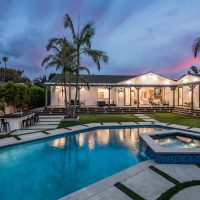 A backyard pool in a verdant garden setting in a modern new construction home in Los Angeles